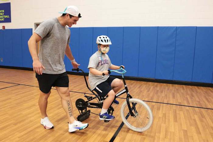 Jacksonville Jaguars kicker Josh Lambo(left) guides 10-year-old Drew Crass, during Tuesday's IBike Camp at the North Florida School of Special Education. Lambo sponsors the camp's first appearance in Jacksonville, and helped in sessions. © Lawren Simmons/Florida Times-Union